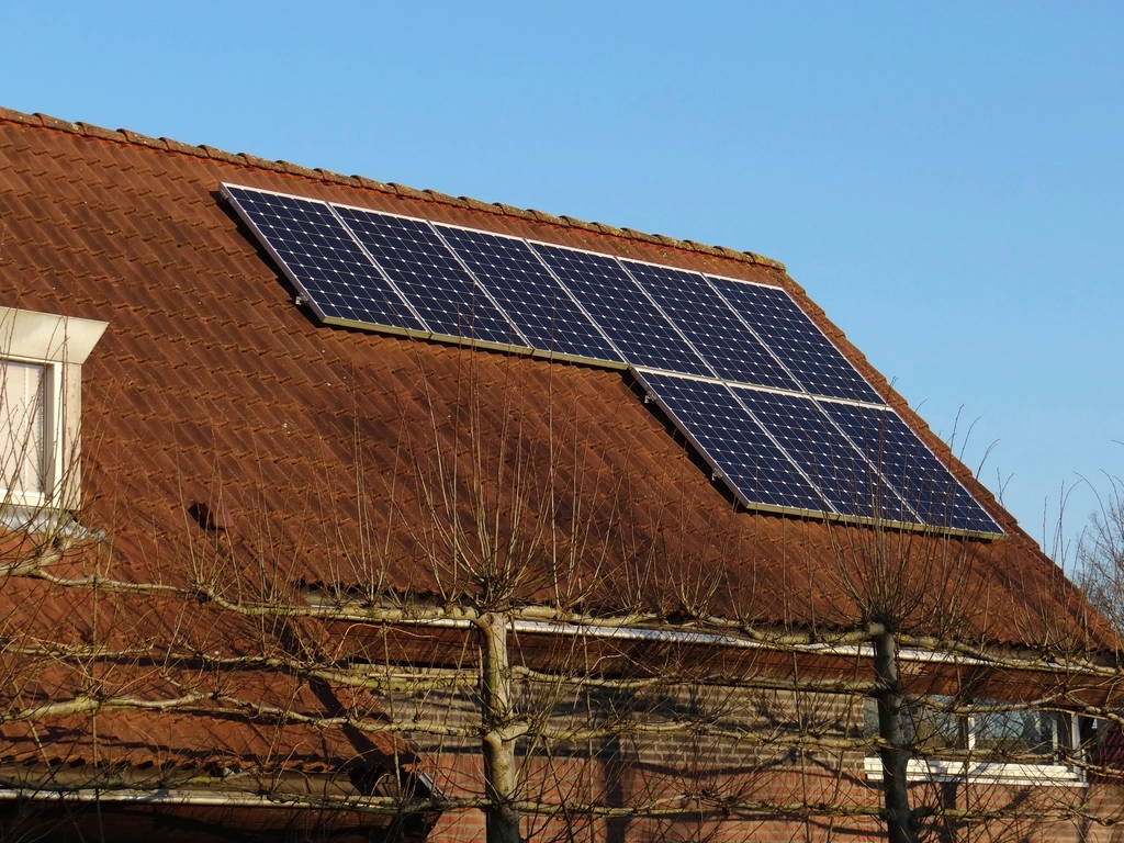 Rooftop solar panels on a home under a clear sky